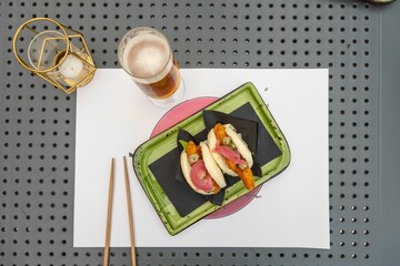 Top view of Chinese traditional chicken bao served on a green plate