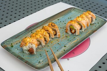 Sushi rolls with chopsticks on the plate