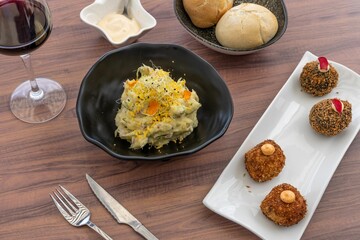 Top view of shrimp and crab risotto and variety of delicious dishes on a wooden restaurant table