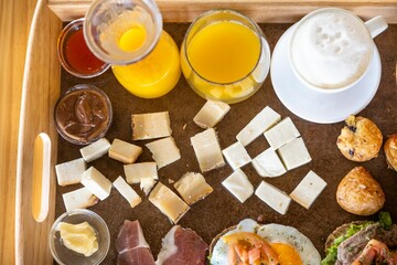 Top view of a food tray filled with different variations of food and drinks
