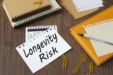 LONGEVITY RISK. beautiful yellow notepad on the work table. text on the page