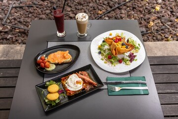 Closeup of delicious served food and cocktails on a table in a restaurant