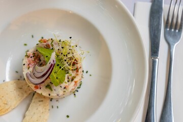 Top view of a unique salad on a white plate laid on a table