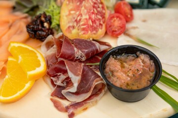 Closeup of a Charcuterie plate on a green tablecloth