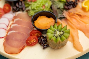 Closeup of a Charcuterie plate on a green tablecloth