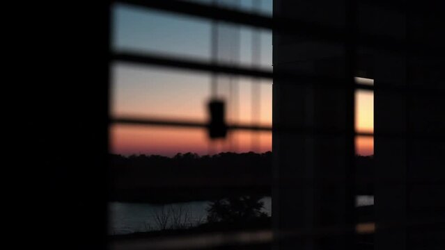 Silhouettes of railings and a beautiful pink sunset over the mountains