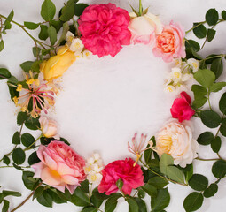 a wreath of English roses, jasmine and honeysuckle on a light background
