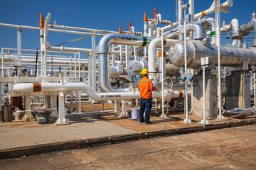 Male worker inspection at the exchanger of tank oil refinery pipeline plant steam vessel and column...