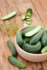 fresh cucumbers in a wooden bowl