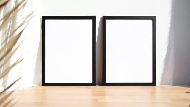 Two black photo frames video mockup on wooden table