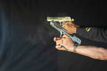 Desert eagle pistol shooting at a target, weapon recoil, soft focus photo.