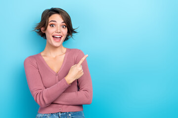 Photo of astonished positive girl open mouth indicate finger empty space isolated on blue color background - obrazy, fototapety, plakaty
