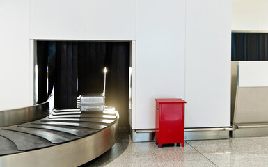 Suitcase or baggage on belt in arrivals lounge of airport terminal
