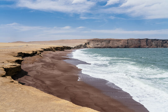 waves on the red beach in peru, paracas