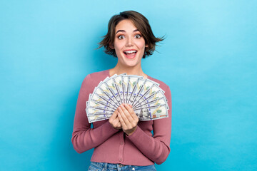 Portrait of impressed ecstatic girl short hairdo wear pink cardigan hold bunch of money win lottery...