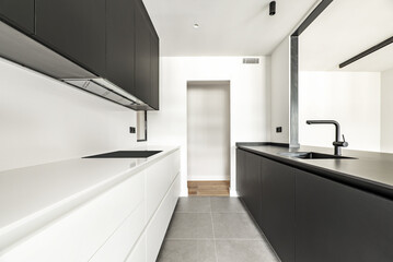 Kitchen furnished with a combination of black