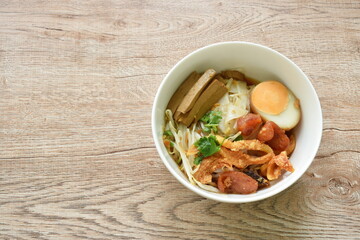 steamed large rice noodles topping slice fried Chinese sausage and pork belly with bean sprout dressing black soy sauce on bowl
