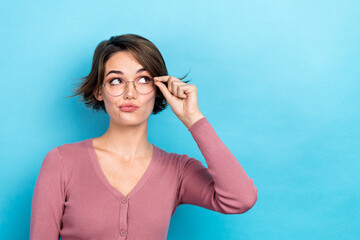 Photo of doubtful unsure lady wear pink cardigan hand arm spectacles looking empty space isolated...