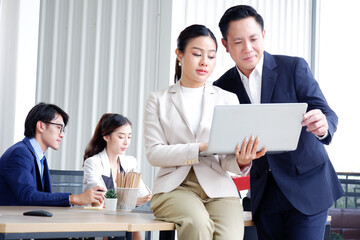 Happy smiling businessman sitting and working inside the office.