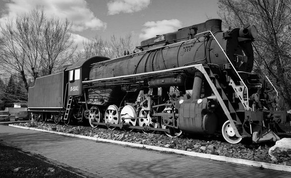 kazakhstan, Ust-Kamenogorsk, may 4, 2023: Old soviet locomotive next to the railway station. The station "Zashchita" Black and white photo