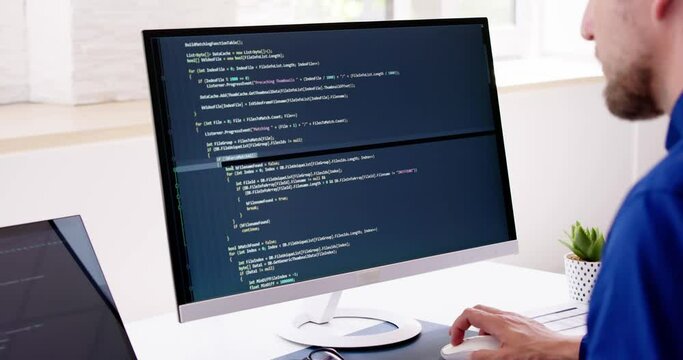Computer Programmer Writing Program Code On Computer