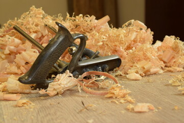 Combination plane and a pile of pine shavings. Woodworking by hand.