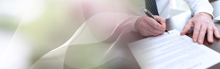 Hand of businessman signing a document (lorem ipsum text used); panoramic banner