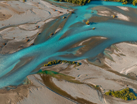 Aerial Drone View of braided river with glacial meltwater blue in New Zealand.
