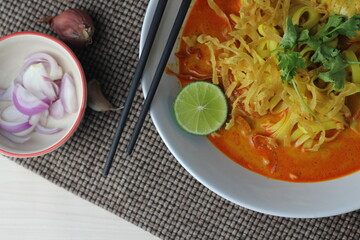 Khao Soi or Spicy Khao Soi is a popular Thai food, top view, flat lay