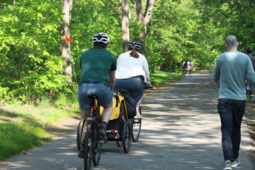 Mother's bike pulling a children bike trailer, people cycling, Jogging and walking on the bikeway