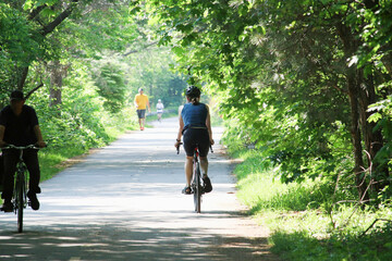People cycling, Jogging and walking on the bikeway in the sunny day