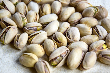 Tasty pistachio nuts. Healthy organic food. Pistachios in shell as background and texture. Close-up. Copy space. Selective focus.