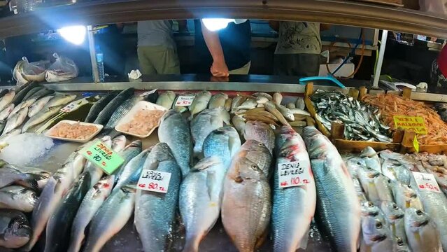 Fresh seafood, shellfish and fish in Fethiye Turkey Market. Camera panning across the market stalls with fish. Slow motion. Fresh fish on the counter at the fish market. High quality FullHD footage