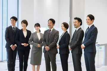 Businessman team looking up Multiple people all gathered with space for copying above Front Front, gender and age diverse team