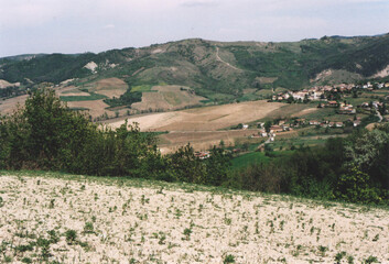 Obraz premium Beautiful Hill Landscape with a Small Village in Northern Italy during Spring. Fortunago, Pavia Province. Film Photography