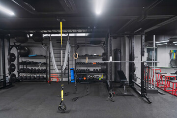 An empty modern gymnasium with a variety of equipment, offering a spacious, functional, and well-equipped training facility for workouts, fitness, and strength training