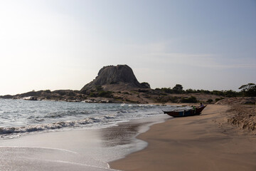 view over beach shore with a rock on the background