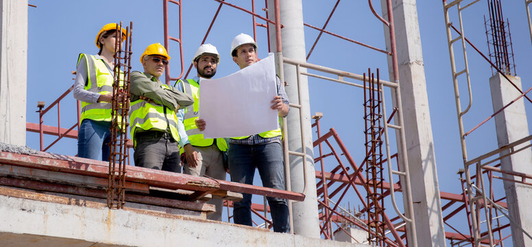 Team group of contractor and architect with foreman explaining about scheme building site for planning project to worker and looking blueprint, construction site, development and structure.