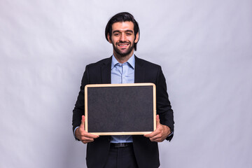 Businessman holding chalk board on white background. Handsome businessman holding black board. Handsome man holding small framed blackboard