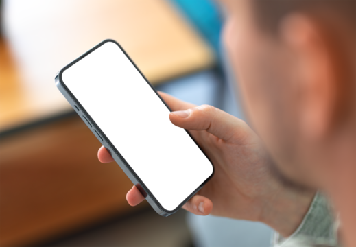 Man using smartphone with blank screen and frameless modern design while sitting on the sofa in home interior - Powered by Adobe