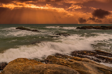 Fototapeta premium beautiful sunset over the indian ocean with rocks in the foreground sri lanka