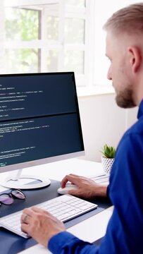 Computer Programmer Writing Program Code On Computer