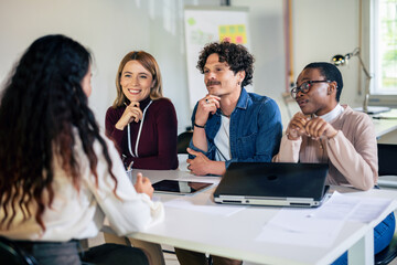 Human resources managers conducting job interviews with applicants in the office