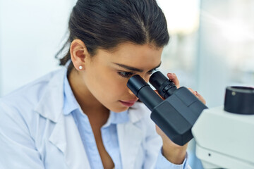 Research, woman and scientist with microscope in lab for medical study. Healthcare, science and female doctor with scope equipment for sample analysis, particle testing and laboratory experiment.