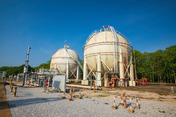 White spherical propane tanks containing fuel gas