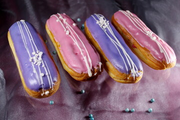 french dessert Eclair cake with pink  violet creme shining decoration Filling and glaze with...