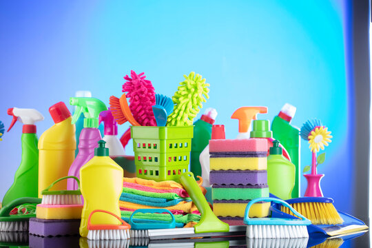 Spring cleaning. Cleaning products. Colorful cleaning kit on blue background.