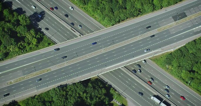 Aerial View of Traffic over a Major Highway Interchange, Full of Cars and Trucks. Daytime in Freeway of London England. Transportation.