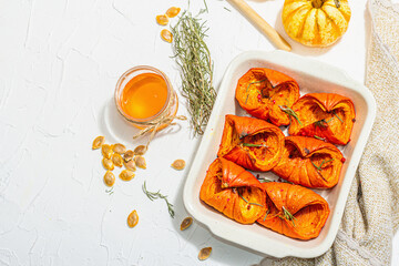 Oven baked pumpkin slices with honey, rosemary and seeds. Vegan food, trendy hard light, dark shadow