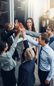Motivation, high five and success with business people in office for support, winner and teamwork. Collaboration, diversity and community with group of employees for solidarity, target and goals